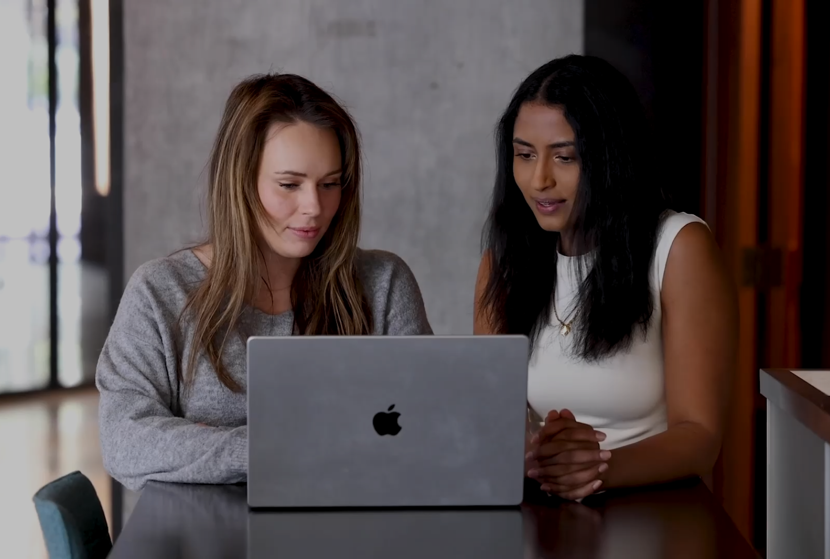 2 women in front of a laptop